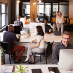 Elevated view of business colleagues working in a busy coworking office
