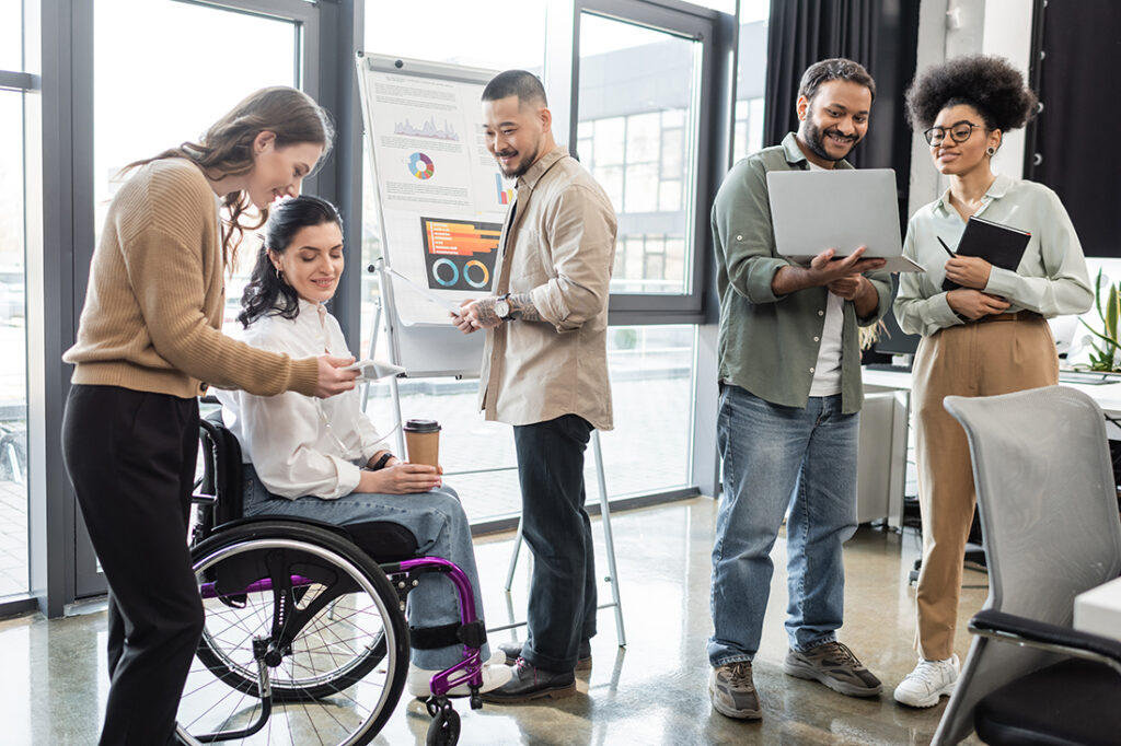 Diversity and inclusion in the workplace as a diverse group of coworkers work on a project together