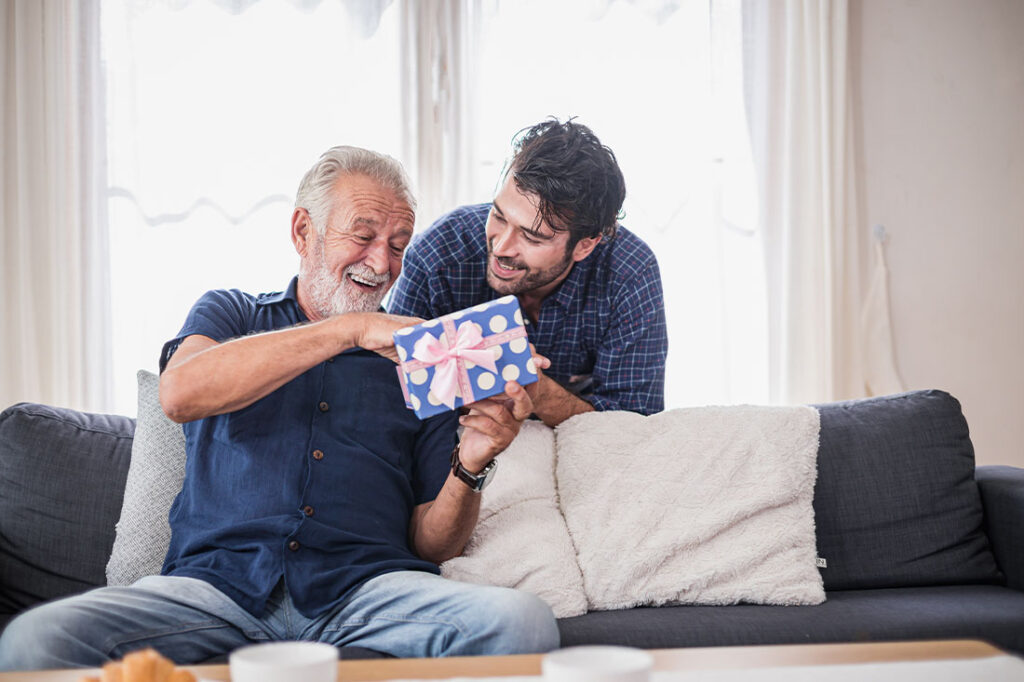 Older man opens the gift box the son gave