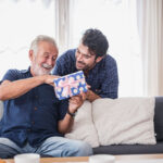 Older man opens the gift box the son gave