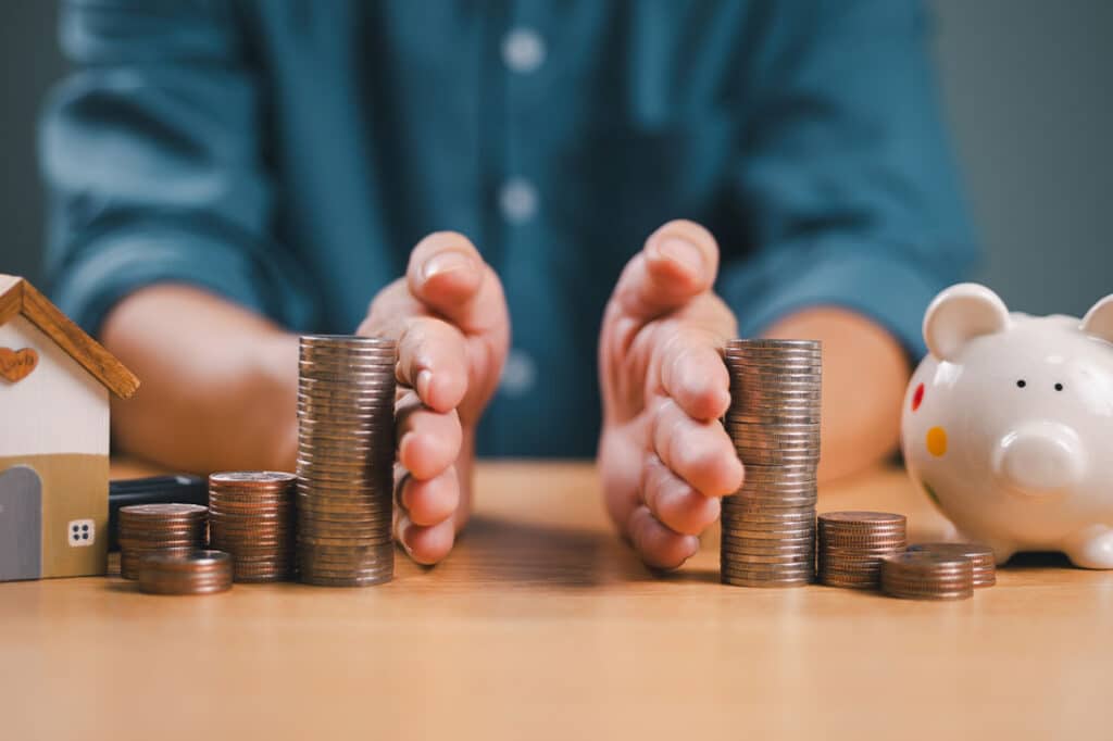 Hands separate coins on table