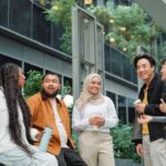 A group of diverse professionals talking outside a building