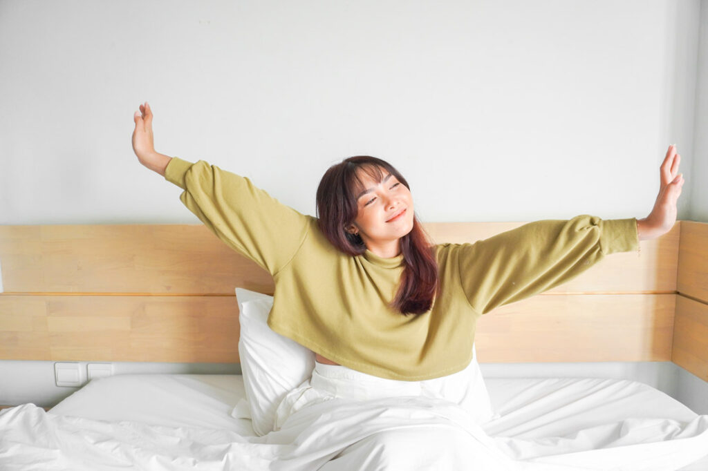 young women waking up in the morning with a smile