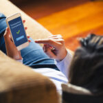 women using the rocket money app on her phone