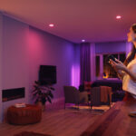 A woman using smart lighting in her home